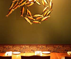 Art on the wall - gold colored school of fish